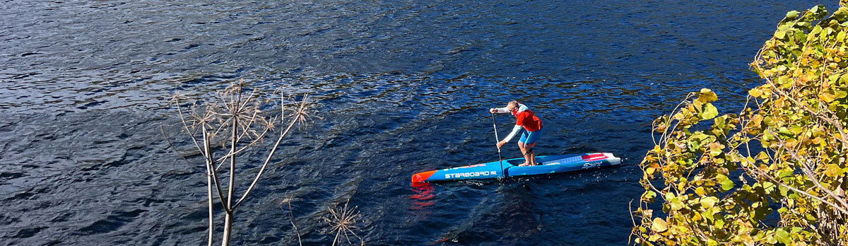 coach jonathan bischof paddle boarding in vermont fall